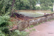 Eine kleine Brücke steht komplett unter Wasser.
