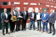 In Kirchensittenbach haben zwei Männer eine besondere Ehrung bekommen. Vor einem frisch renovierten Gebäude aus dem 16. Jahrhundert hat sich die Gesellschaft zum gemeinsamen Foto aufgestellt.