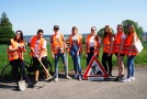 Acht Schülerinnen und Schüler mit Warnwesten bekleidet posieren für ein Gruppenfoto.